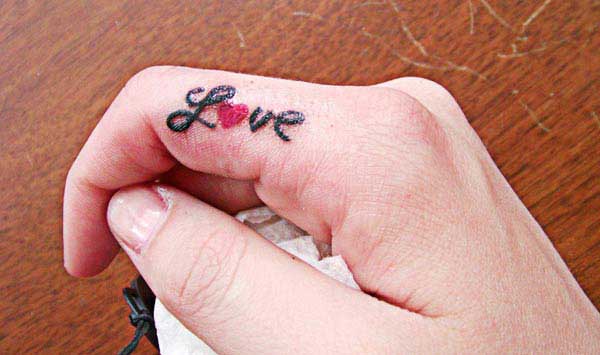 pretty finger tattoos