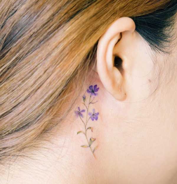 flower behind the ear tattoos