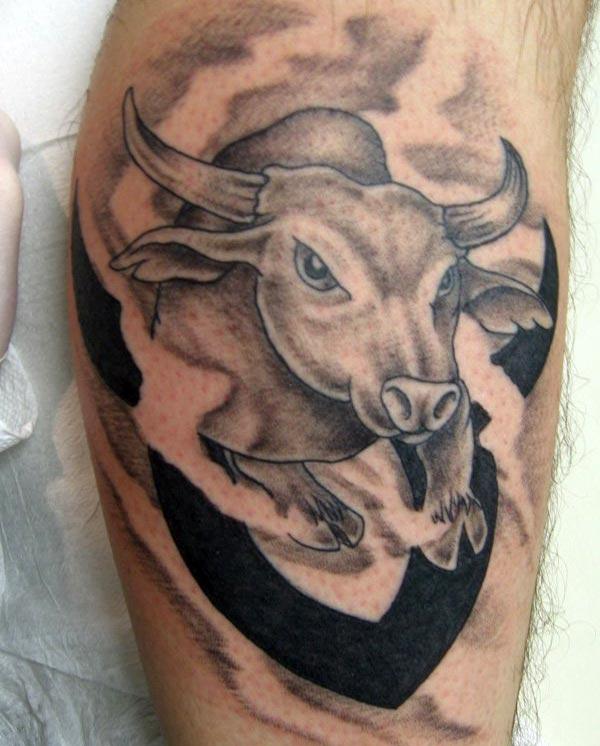get the hunk look with black bull Taurus tattoo on upper arm