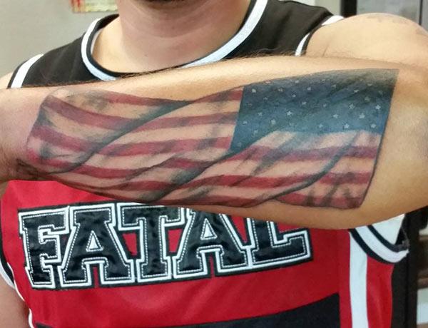 American Flag Tattoo on the lower back arm of the hand make a man look cool