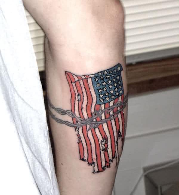 American Flag Tattoo on the lower side arm makes a man have a dapper look