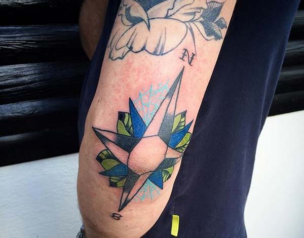 blue compass tattoo design idea on elbow