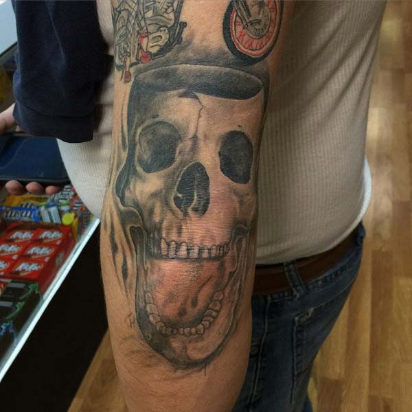 skull tattoo ink design idea for men on the elbow