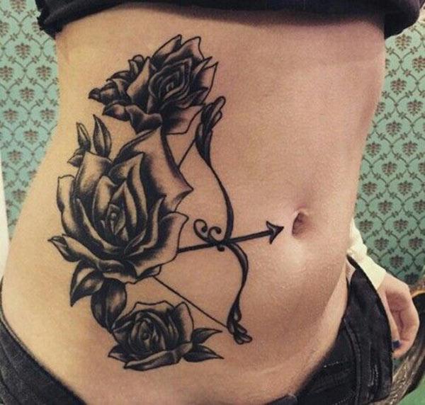 mark your belly with rose embedded Sagittarius tattoo on left abdomen