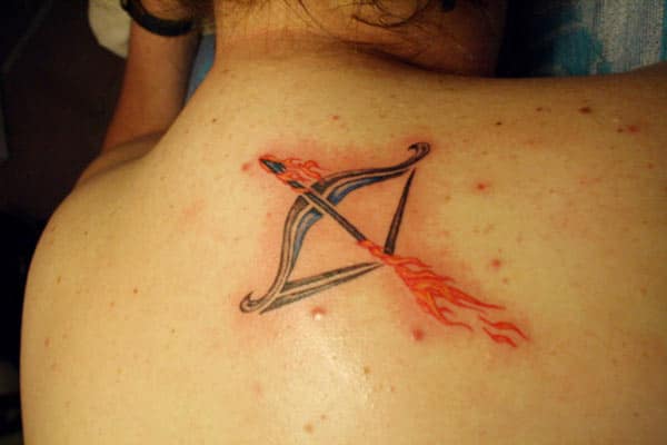 red black archer Sagittarius tattoo on the back show boldness