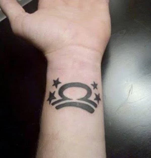 This curved line libra symbol tattoo is made up for the wrist