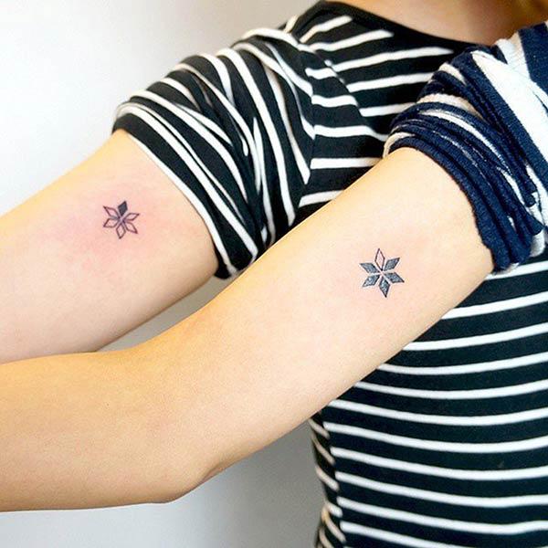 A cute matching tattoo on upper arm for girls and women