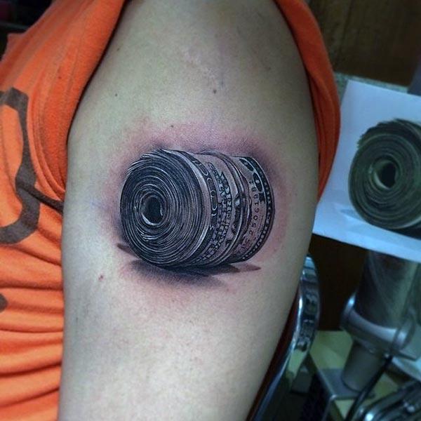 An attractive roll of dollar tattooed on upper arm of a Woman