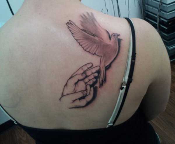 hand and dove tattoo