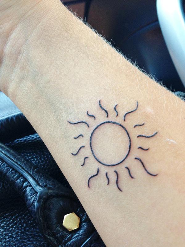sun tattoo on wrist