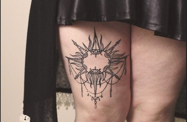 sun tattoo on thigh