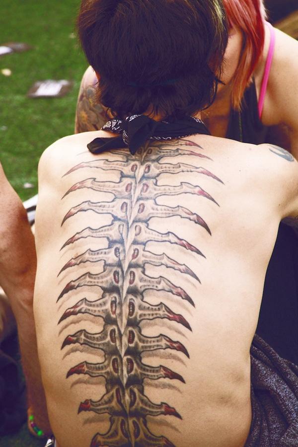 Spine tattoo on the back makes a woman look mesmeric and artful