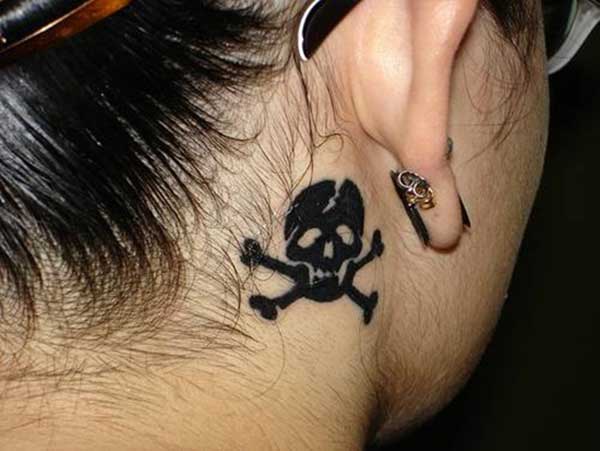 skull behind the ear tattoos