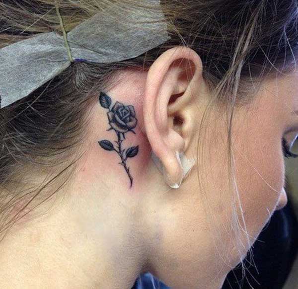 flower behind the ear tattoos