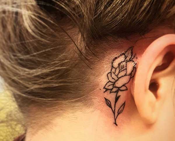 rose behind the ear tattoos