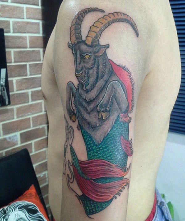 Capricorn tattoo on the left upper arm make a man look elegant 