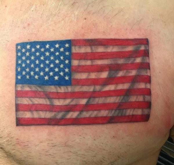The American Flag Tattoo on the upper chest make a man have a majestic appearance