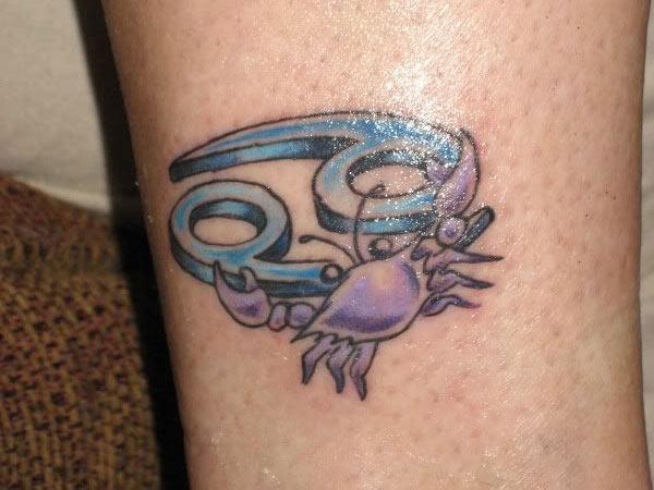 The blue and purple ink design of the Cancer Zodiac Tattoo on the foot gives a flashy look