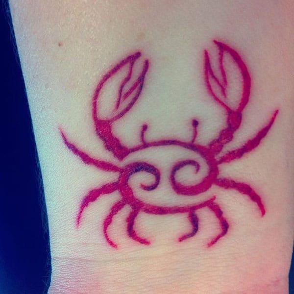 The Cancer Zodiac Tattoo on the foot make a captivating look in a man