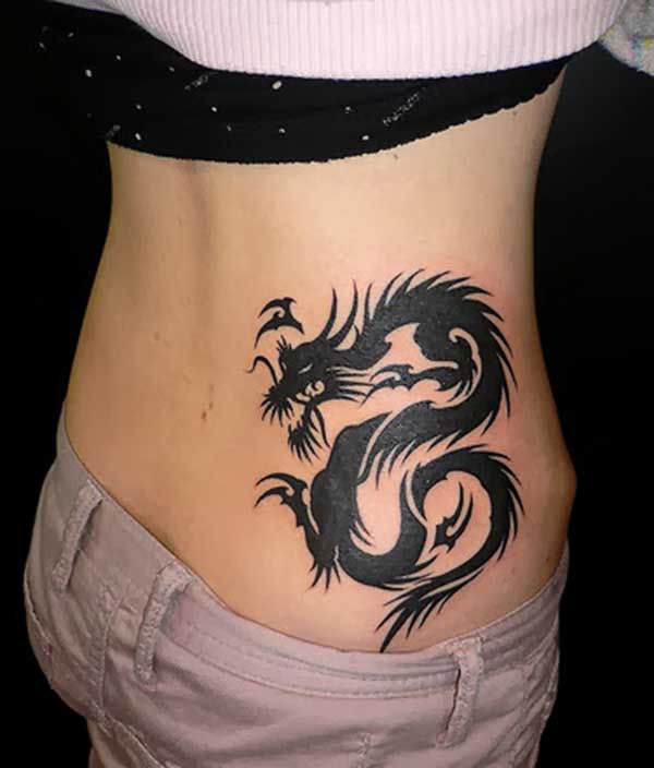 The Girl with the simple black ink dragon tattoo design on her lower back