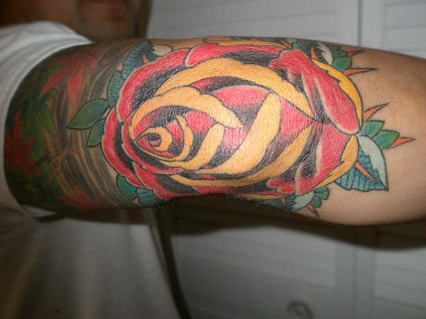 colorful rose tattoo idea for men elbow