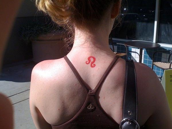 Leo Tattoo on the back neck of a lady makes her to look attractive