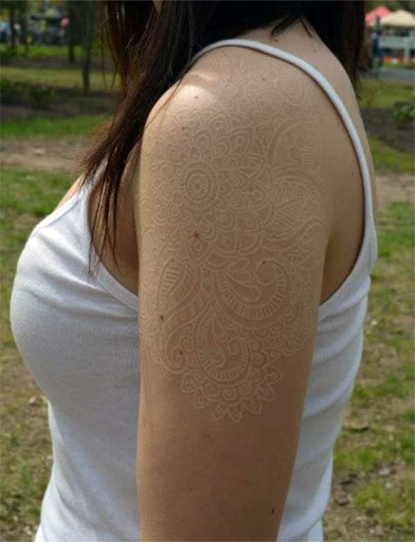 Cool white ink tattoo on girl shoulder