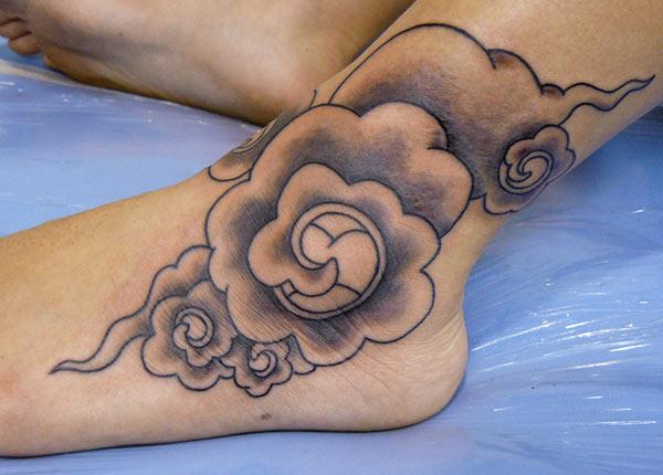 Cloud Tattoo with a purple ink design on their foot make a girl look adorable