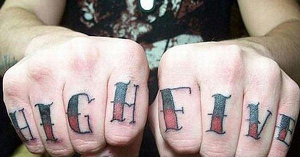 Knuckle Tattoo with a pink and black ink design makes a man look imposing
