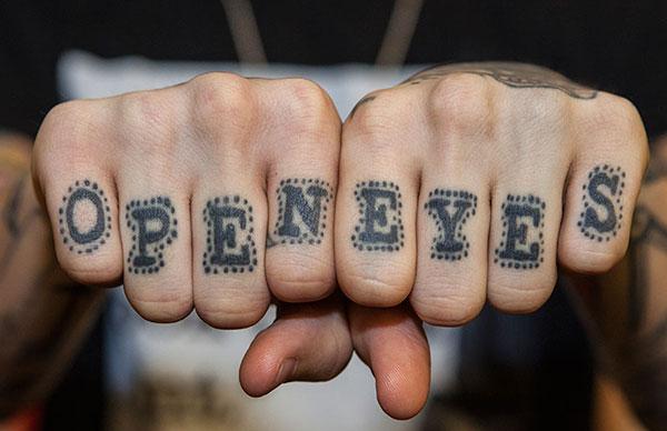 Knuckle Tattoo with a black ink, writing design give men fashionable look