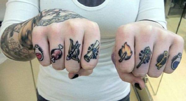 Knuckle Tattoo with drawings make a lady look captivating