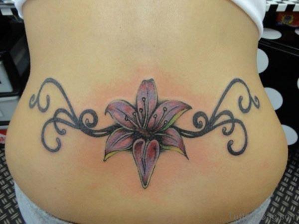 Lily tattoo on the back abdomen make a lady look captivating 