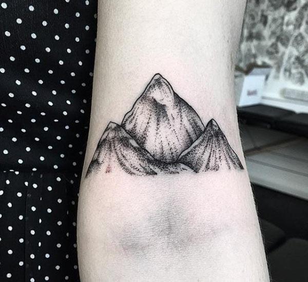 Mountain Tattoo on the hand makes a lady appear radiant 