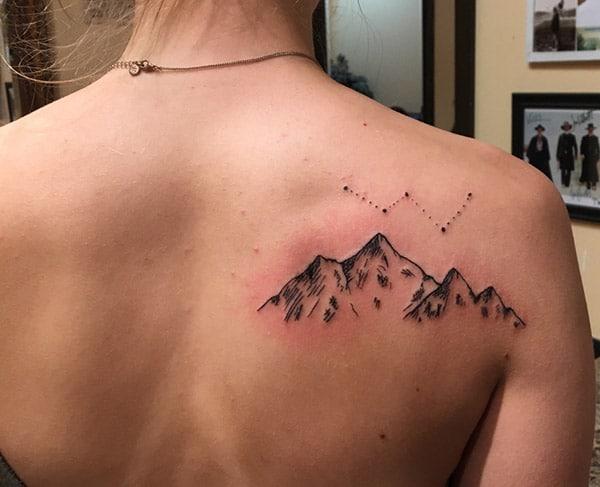Mountain Tattoo at the back makes a woman appear captivating 