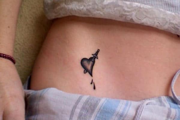 Tiny tattoo on the side waist in ladies brings out their gorgeous look