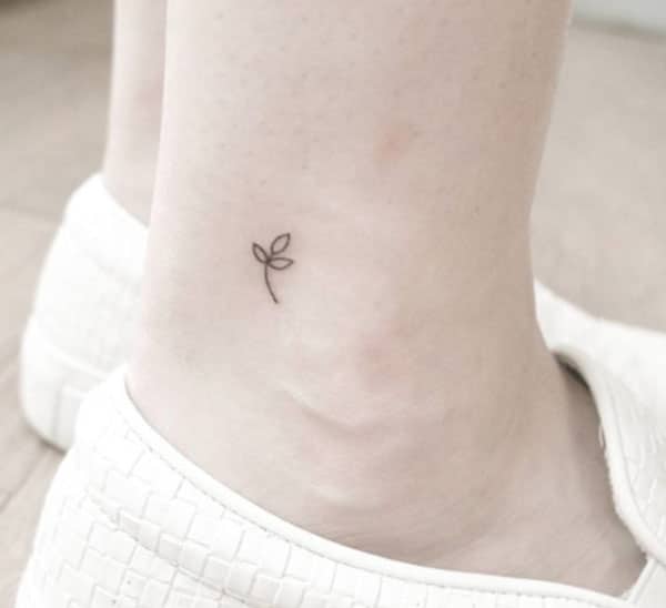 Tiny tattoo with a black ink design flower make them look attractive