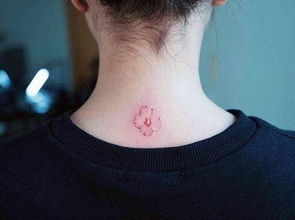 Tiny tattoo on the back neck brings the feminist look