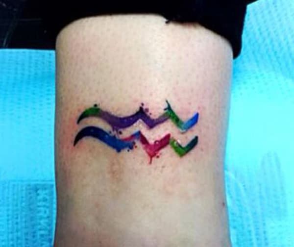 A multi-colored beautiful Aquarius tattoo to display your colorful personality