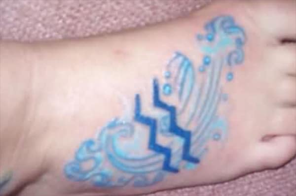 A blue Aquarius tattoo formed up a great designing combination