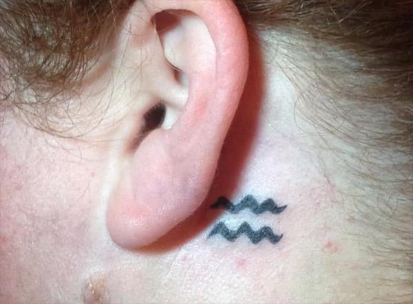 A sneak peak of the Aquarius tattoo behind your ear
