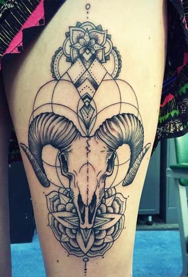 The awesome Aries tattoo design on lower thighs for women