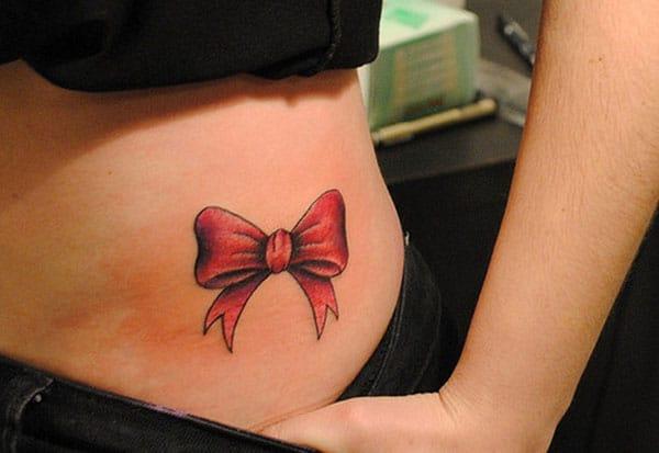 Bow tattoo on the side waist in ladies brings out their gorgeous look