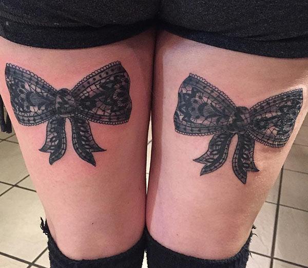 Bow tattoo for the upper thigh brings their feminist look