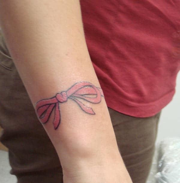 Girls go for a bow tattoo at the back of their hands to bring their pretty look.