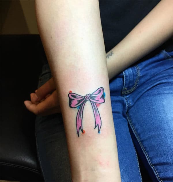 Bow tattoo on the girl hand give her the Fabulous gaze