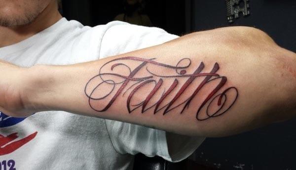 faith tattoo on lower arm make a man look cool