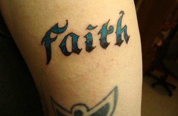Upper arm faith tattoo looks bold and husky for men