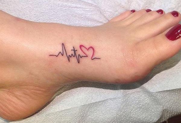 Making Heartbeat Tattoo with a pink love ink design makes a women look attractive 