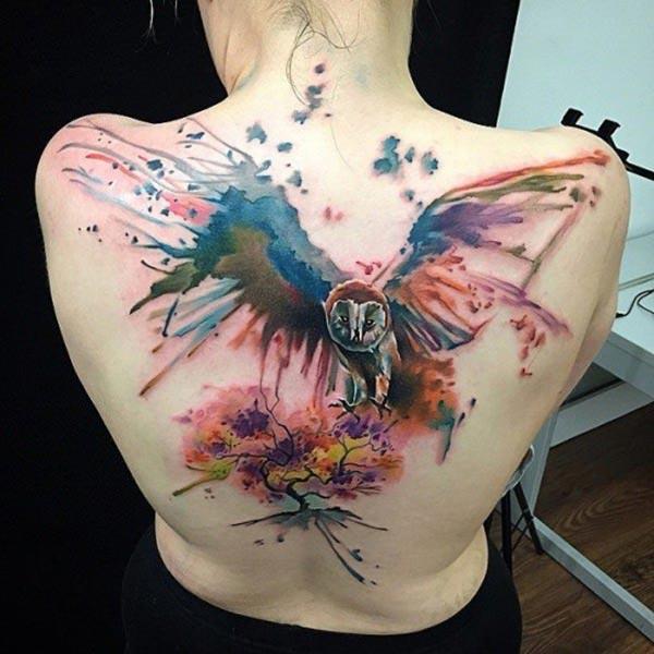 Owl Tattoo on the back with blue and pink ink design brings a gorgeous look