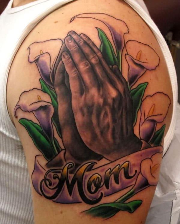 Praying Hand Tattoo on the shoulder with a flower makes a man look comely and gallant